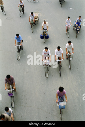 Cina, Pechino, gente in bicicletta in strada, vista in elevazione Foto Stock