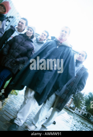 Un gruppo di giovani sul marciapiede, inclinazione Foto Stock