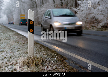 Traffico invernale, guida auto da riflettore post con i fari accesi, Hesse, Germania, Europa Foto Stock