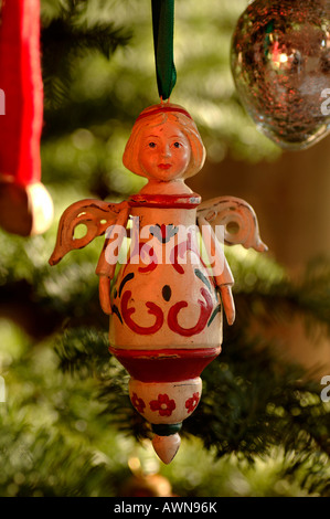 Angelo scolpito ornamento di Natale appeso nella struttura ad albero Foto Stock