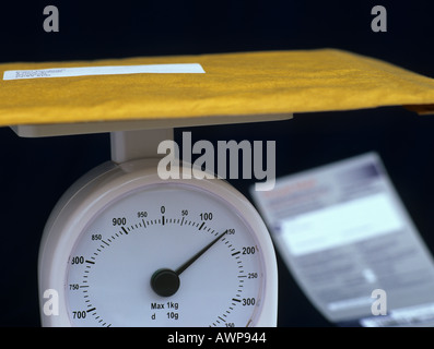Parcella su bilance con Royal Mail consegna speciale forma sfumata dietro Foto Stock