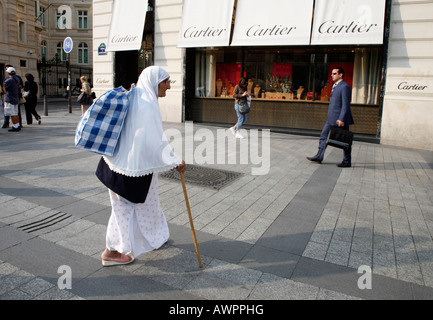 Mendicante di fronte al Cartier boutique su Avenue des Champs Elysées a Parigi, in Francia, in Europa Foto Stock