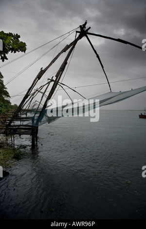 Cinese di reti da pesca Cheenavala sospesa a mezz aria al crepuscolo dopo la giornata di lavoro Fort Kochi beach Kerala India del Sud Foto Stock