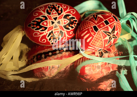 Due dipinte a mano tradizionale rosso e nero ceco geometrico le uova di pasqua con aqua e nastro giallo Foto Stock