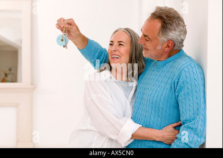 Coppia matura sorridente, uomo mostra chiave, close-up Foto Stock