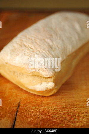 Il pane artigianale, ciabatta, su un bordo di taglio Foto Stock