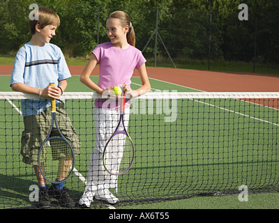 Ragazzo e una ragazza in un campo da tennis Foto Stock