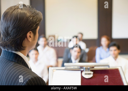 Il profilo laterale di un imprenditore dando una presentazione in sala conferenze Foto Stock