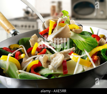 Ortaggio friggere in un wok viene agitato con funghi Oyster, peperoni, pak choi e verdure Foto Stock