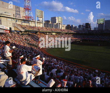 Il giapponese gli appassionati di baseball di Hiroshima Carp allietare il loro team su a Hiroshima Baseball Stadium. Foto Stock