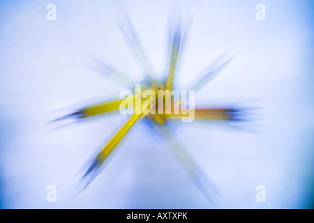 Vista dall' alto verso il basso sul polistirolo tazza riempita con giallo matite appuntite sulla scrivania con il fuoco selettivo e la sfocatura del tono di colore Foto Stock