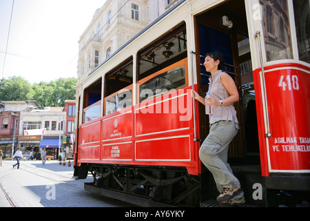 Donna di scendere dal tram su Viale Istiklal Beyoglu Istanbul 2010 Capitale europea della cultura Turchia Foto Stock