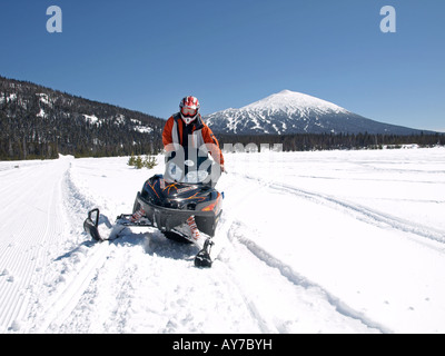 Un snowmobiler teste per Elk Lake Resort da Mount Bachelor Ski Area lungo la cascata Autostrada dei Laghi Foto Stock