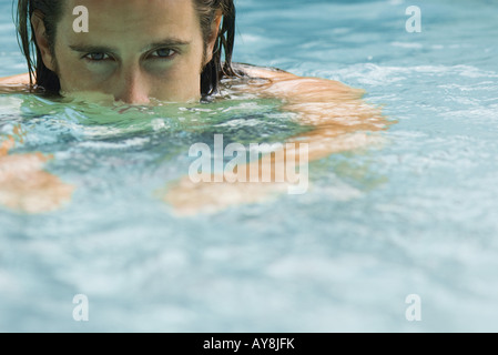 Uomo in piscina, guardando la telecamera, close-up Foto Stock
