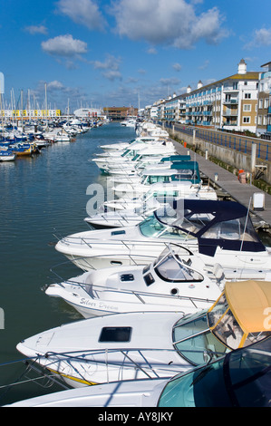 Una riga bianca di barche a motore ormeggiato a Brighton Marina nel Sussex, Inghilterra. Foto Stock