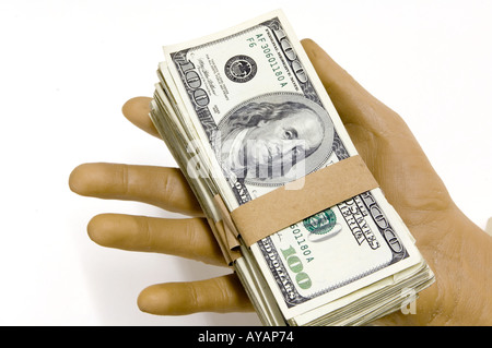 hand holding  packs  100 dollar bills US concept Foto Stock