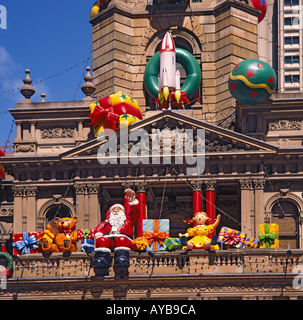 Il Municipio facciata decorato per il Natale con enormi aria gonfiata compresi i giocattoli di Babbo Natale sventolando in Sydney Australia Foto Stock