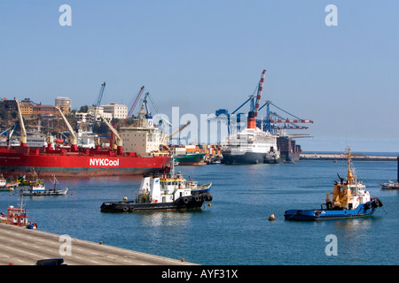 La regina Elisabetta II la nave di crociera di una nave portacontainer e tirare le barche nel porto a Valparasio Cile Foto Stock