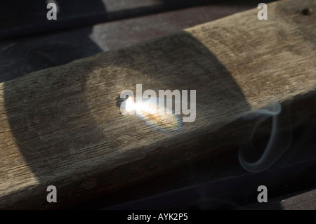 Lente di ingrandimento utilizzata per bruciare il legno Foto Stock