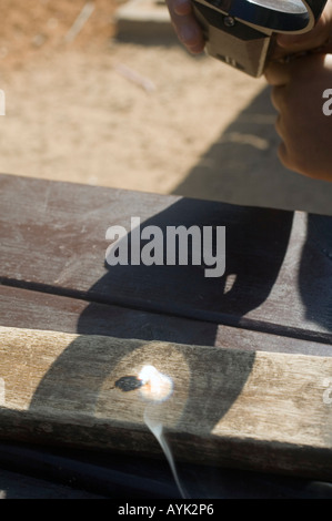 Lente di ingrandimento utilizzata per bruciare il legno Foto Stock