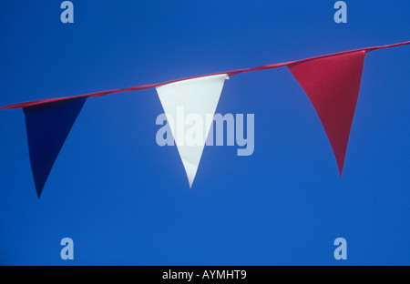 Dettaglio della bandiera di plastica bunting mostra blu bianco e rosso Bandiere triangolari contro il cielo blu chiaro Foto Stock