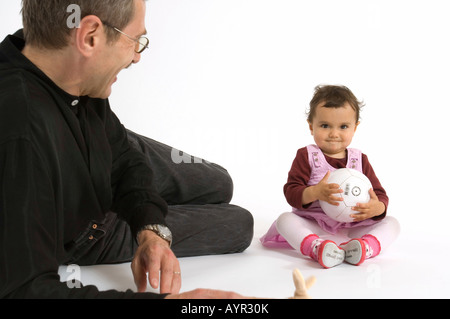 Padre guardando la sua giovane figlia giocare Foto Stock