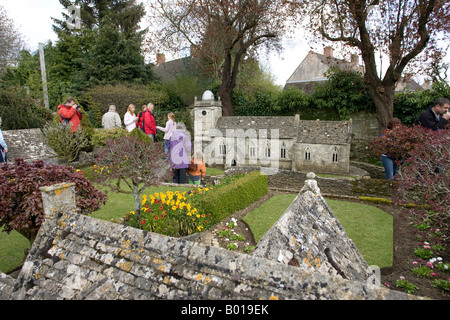 Ai visitatori di ammirare miniatura di St Lawrences chiesa model village Bourton sull'acqua Costwolds REGNO UNITO Foto Stock