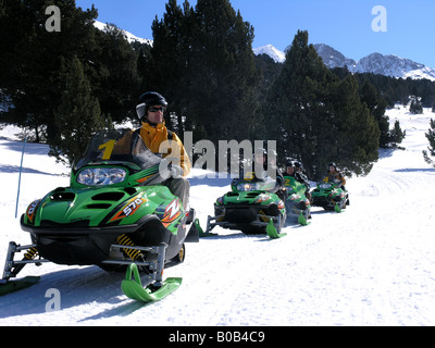 I turisti in Snowmovile avventura sport Pirenei Andorra Foto Stock