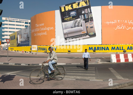 Un lavoratore straniero passa di fronte a un annuncio di IKEA in una strada di Dubai. / Migrante Travailleur passe devant une publicité pour IKEA / Werbung für Ikea. Foto Stock