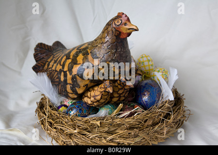 Una decorazione di Pasqua, intagliato a mano e pollo pulcini con una decorazione di uova in un nido, Surrey, Inghilterra. Foto Stock