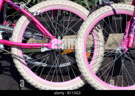 Due bambini rosa PUSHBIKES CONCATENATI ORIZZONTALE11197 BDB Foto Stock