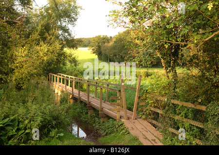 Piccolo ponte in legno sul fiume a scacchi in Chorleywood REGNO UNITO Foto Stock