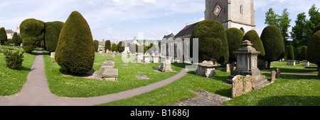 Pietra scolpita tombe e alcuni dei 99 yew alberi nel cimitero del villaggio Costwold di Painswick, Gloucestershire Foto Stock