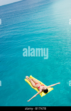 Donna sul galleggiante in acqua Foto Stock