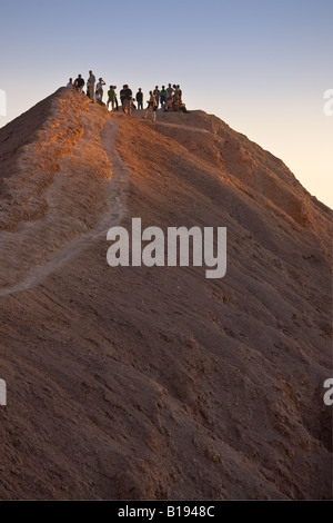 I turisti in attesa per il tramonto nella Valle de la Luna a valle della luna nel deserto di Atacama nel Cile settentrionale Foto Stock