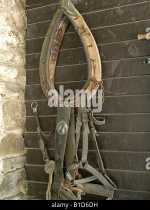 La forcella del cavo di righe di vecchi gioghi per cavallo appeso alla parete di un fienile in città Mozirje Foto Stock