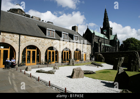 Città di Glasgow, Scozia. Il giardino e il cafe al St Mungo Museum di vita religiosa e di arte, la cattedrale di Glasgow è in background. Foto Stock