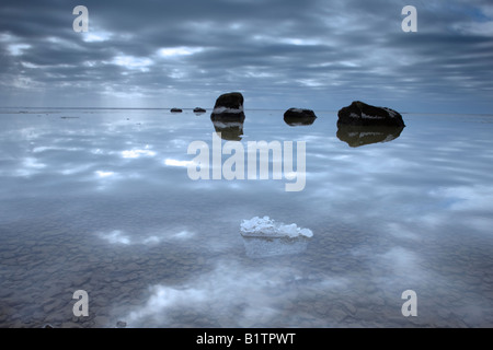 Sky riflessa nell'acqua con rocce, Reykjavik, Islanda Foto Stock