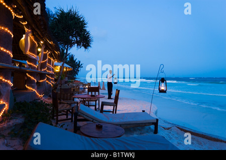 Cameriere lanterne disponendo le sabbie al Nomad Diani Beach Kenya Foto Stock