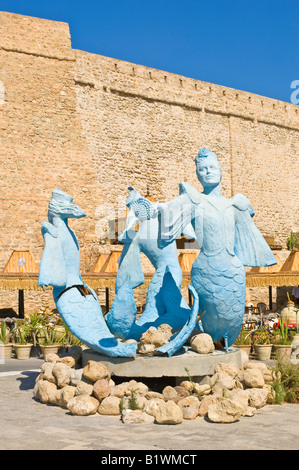 Al di fuori delle mura della medina di Hammamet sulla costa mediterranea è questa illustrazione statua di tre sirene blu. Foto Stock