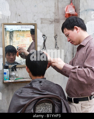 Aria aperta street barbiere, centro di Hanoi, Vietnam Foto Stock