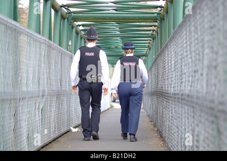 Un funzionario di polizia e il sostegno comunitario Officer pattugliano le strade Foto Stock