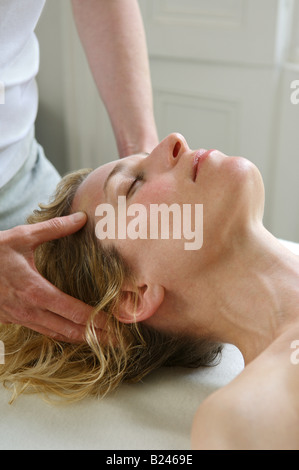 Una donna con un massaggio Foto Stock