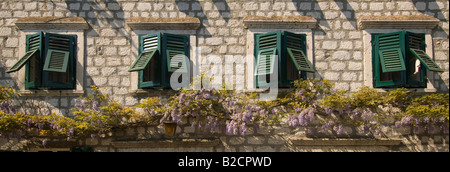 Vista panoramica di finestre con persiane su casa colonica nel villaggio di Prcanj nei pressi di Kotor in Montenegro. Foto Stock