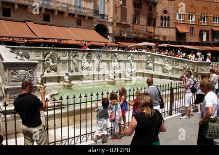 I turisti al di fuori della fonte gaia o fonte di gioia piazza del campo a siena toscana italia meridionale in europa Foto Stock