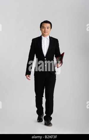 Ritratto di un maschio di fortune teller tenendo un cinese feng shui bussola Foto Stock