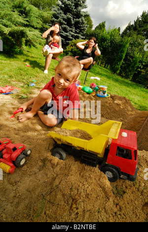 Baby boy ragazzi con la madre nella buca di sabbia a giocare giochi Parco giochi 2 per 3 anni Foto Stock