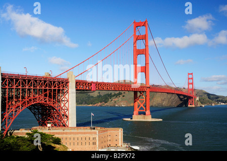Golden Gate Bridge e Fort Point in una bella mattina invernale contro uno sfondo di cielo blu con nuvole bianche Foto Stock