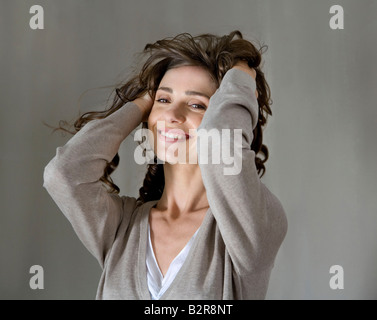 Ritratto di donna con le mani nei capelli Foto Stock