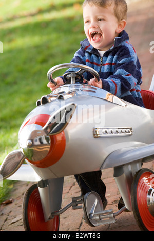 Giovane ragazzo giocando all'aperto in aereo sorridente Foto Stock